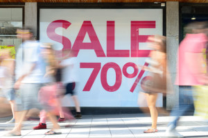 Shop sale sign, motion blurred pedestrians